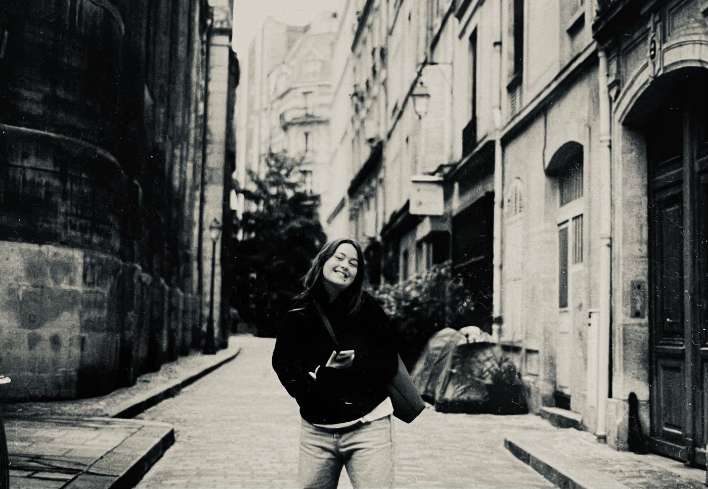 Luna Rosa Kristiansen laughing in a narrow city street
